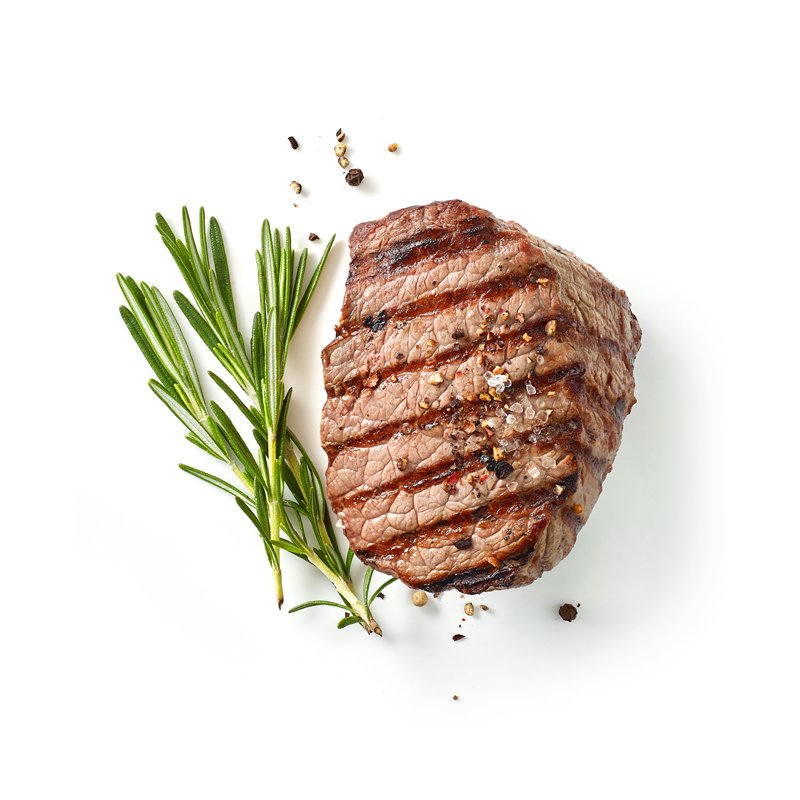 Life Extension, grilled beef steak seasoned with black pepper and mineral salt with rosemary sprig on its left, on white surface background